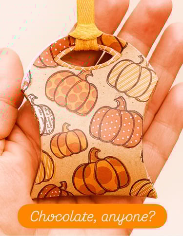 hand holding treat pouch with chocolate