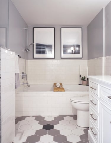 a bathroom with a white toilet and a hex pattern floor