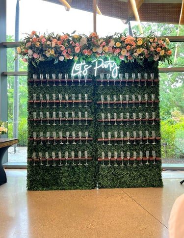 a wall of wine glasses with a green champagne wall wall