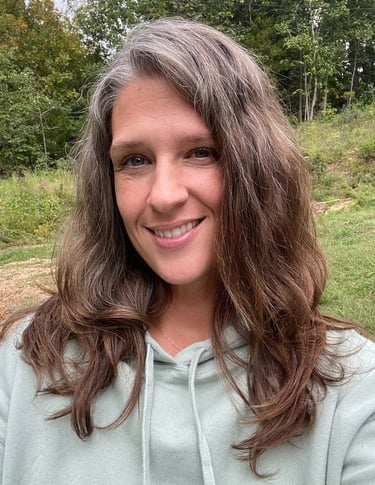 a woman with long hair and a green hoodie