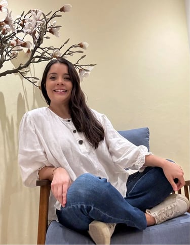 a woman sitting on a chair in a room