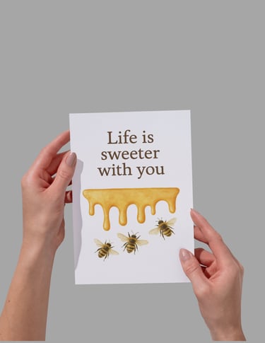 Hand holding a greeting card with dripping honey and bees that says Life is sweeter with you.