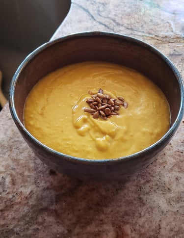 a bowl of soup with sunflower seeds in it