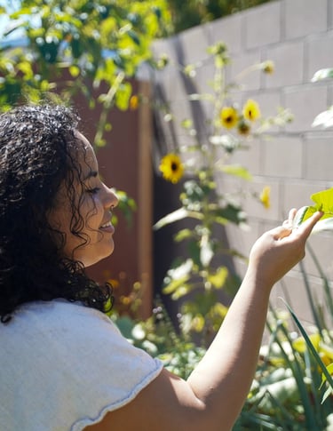 Iveth Balanta holding a leafy plant in her hand