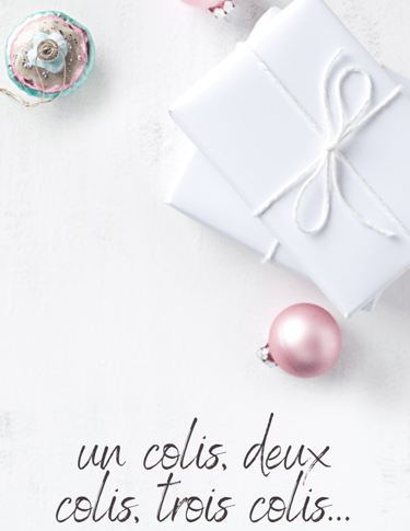 a white gift box with a pink ribbon and a pink ornament