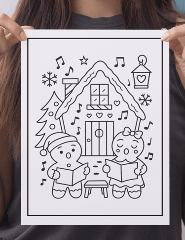 a woman holding up a drawing of a house