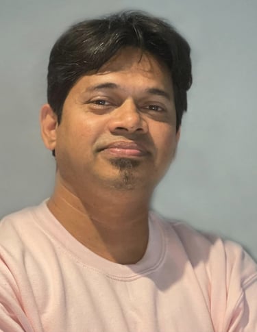 a man with a pink shirt and a cell phone - Radyan Raheev