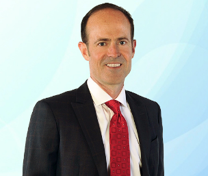 a man in a suit and tie with a red tie - Wiley Long