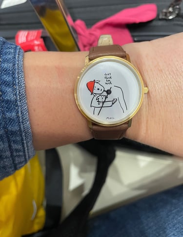 a watch face saying "don't think too much"