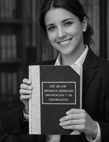 Smiling female lawyer holding a book on general import and export tax laws in a library.