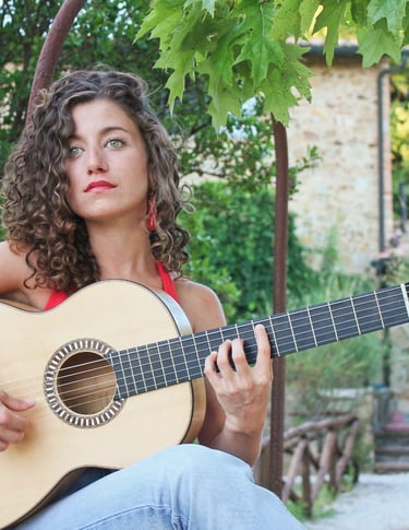 a woman with curly hair and a guitar