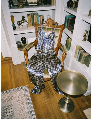 Silk set on vintage chair in home library—visual nod to Sani design background.