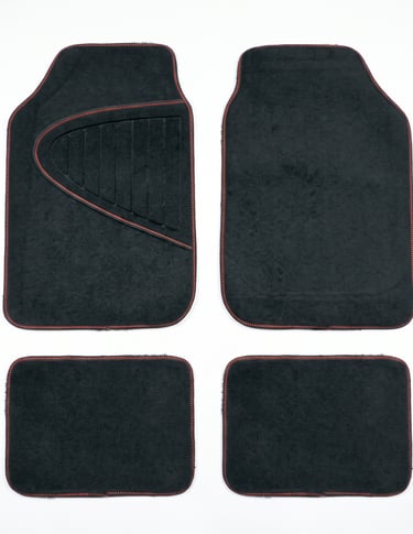 Set of four black carpet car floor mats with red stitching for vehicle interior protection.