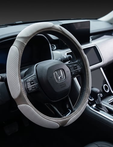 Breathable mesh grey steering wheel cover installed on a Honda car interior dashboard.