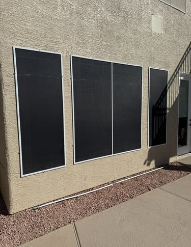 Installed black solar screens covering multiple windows