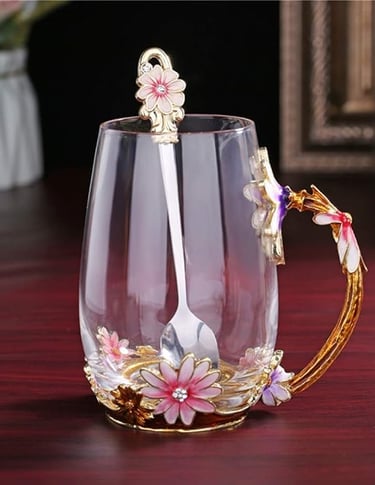 Handmade glass tea cup with enamel butterfly and floral handle, elegant gift idea.