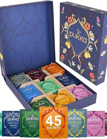 Pukka herbal tea gift box with mixed flavours in colourful sachets, premium wellness gift.