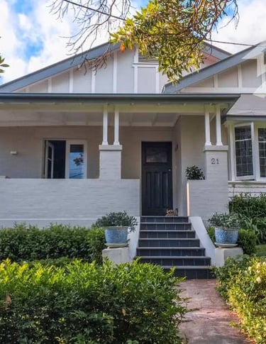 a white house with a white house with a black door and a white house with