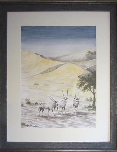 3 Gemsbok/oryx in the Kalahari Desert as the first rays of day's sun tint the edges of the sanddunes
