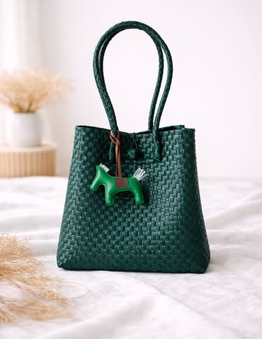 Handwoven bottle green plastic tote bag handmade from recycled materials by Indonesian artisans