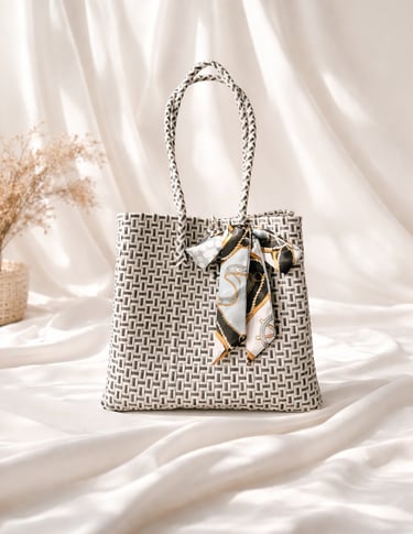 Handwoven white and black plastic tote bag handmade from recycled materials by Indonesian artisans