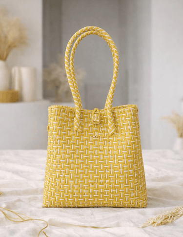 Handwoven yellow striped plastic tote bag handmade from recycled materials by Indonesian artisans