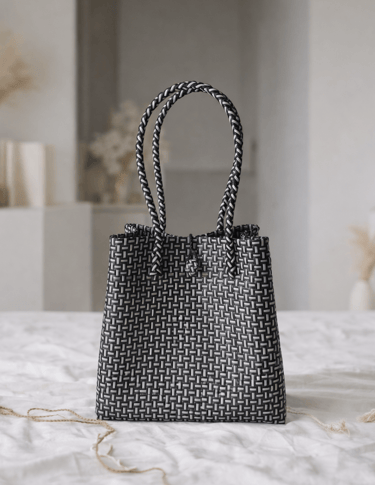 Handwoven black striped plastic tote bag handmade from recycled materials by Indonesian artisans