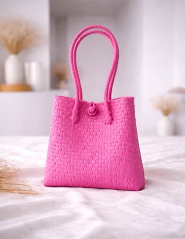 Handwoven fuchsia pink plastic tote bag handmade from recycled materials by Indonesian artisans