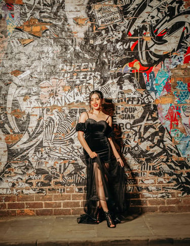Bride posing by a colorful graffiti wall in York’s vibrant streets, captured by Fred Art Studio.
