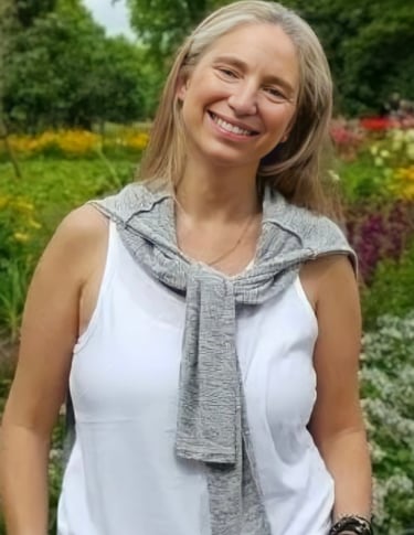 a woman in a white tank top and a gray scarf cecilia aylion
