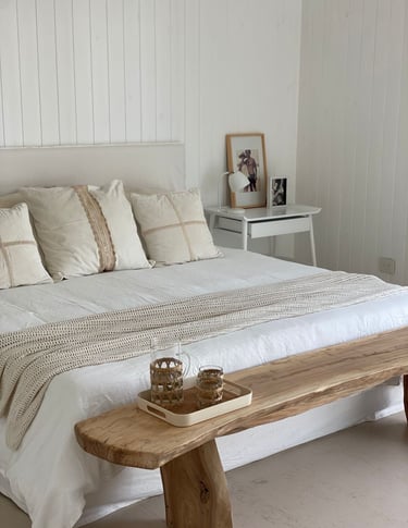 a bed with a wooden bench and a wooden bench with a wooden bench and a