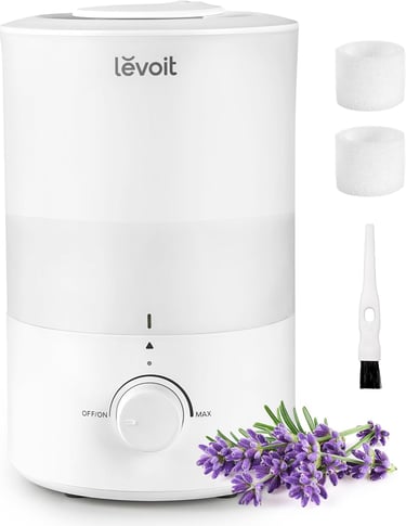 White Levoit humidifier with lavender flowers, two filters, and a cleaning brush