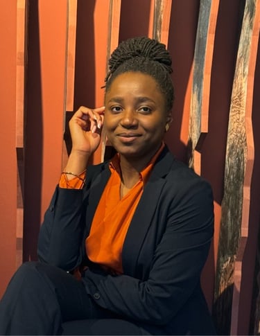 a woman in a suit and orange shirt