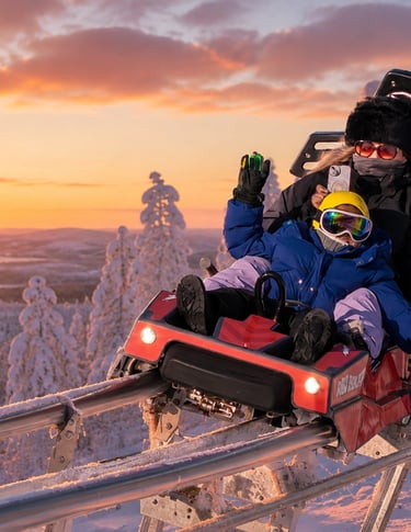 Guests riding the Ruka Coaster through a snowy winter landscape in Ruka, Finnish Lapland.
