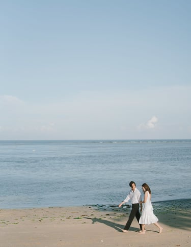 Couple walking along the beach during an intimate photography session at Novotel Bali Benoa in Tanjung Benoa Bali.