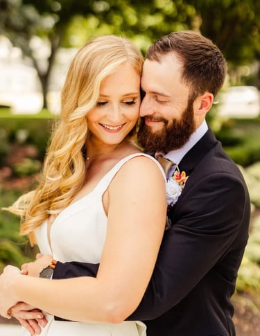 a bride and groom holding one another