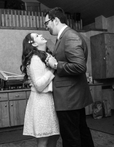 a bride and groom dancing while looking at one another