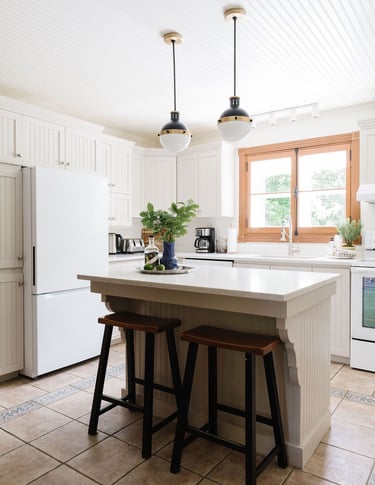 a kitchen with a large island and a white refrigerator