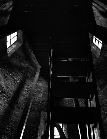 a staircase cased in a tunnel a tower with a ladder, windows