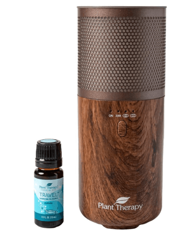 a wooden diffuser with a bottle of essential oils