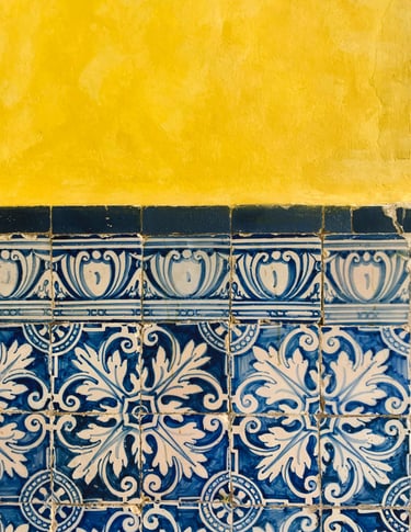 a blue and white tile wall with a yellow wall
