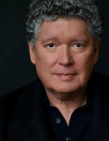 a man with a gray hair and a black shirt