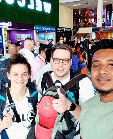 Two international tourists meeting their professional driver at Colombo Airport for a reliable Sri L