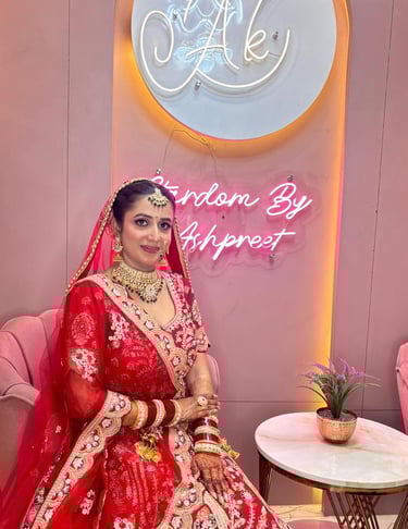 Indian bride in classic red lehenga with HD bridal makeup, gold jewelry, mehendi, and dupatta drape,