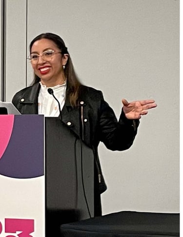 a woman standing at a podium with a microphone