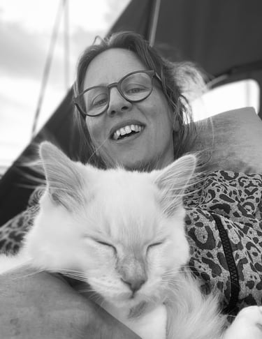 a woman is holding a cat