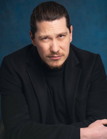 a man in a black suit and a black jacket