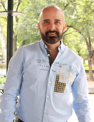 a man with a beard and a tie dye on his shirt