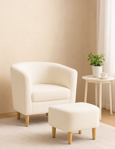 White armchair with ottoman and small side table in a cozy living room