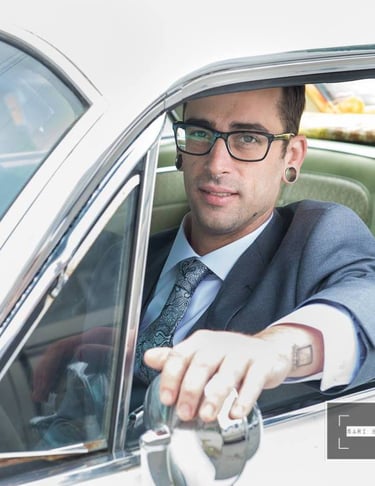 a man in a suit and tie is sitting in a car
